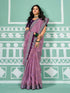 Woman wearing a purple saree with a pattern against a green and white geometric background